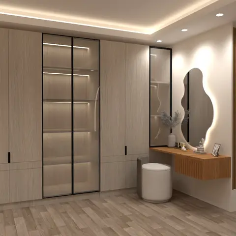 Bedroom dressing area with a full-height light-wood wardrobe wall featuring a glass-front display section