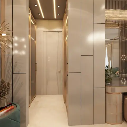 Bedroom looking past an emerald channel-tufted bed and a brass starburst sconce into a champagne high-gloss wardrobe passage