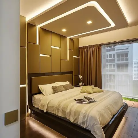 Bedroom seen from the doorway with a floating dark-timber bed glowing on an LED-lit plinth
