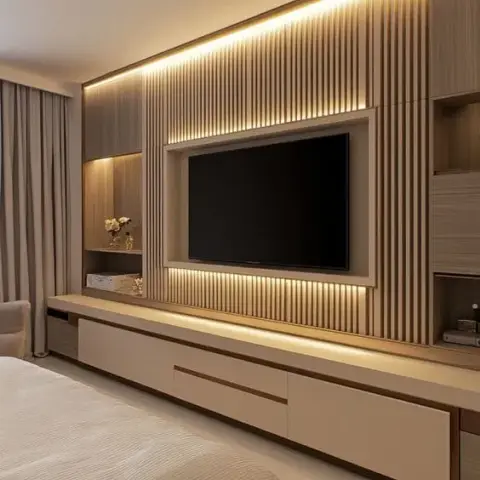 Bedroom TV feature wall with backlit vertical fluted wood panelling and a long floating storage console.