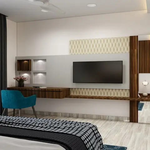 Bedroom TV wall combining a cream diamond-quilted upholstered panel with a walnut floating console and full-length mirror