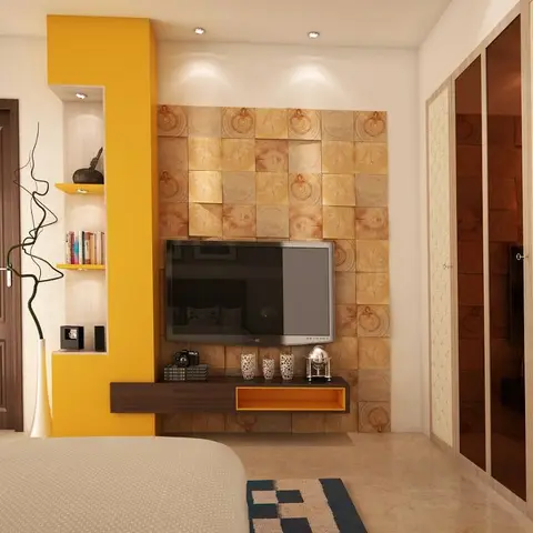 Bedroom TV wall of chunky log-print 3D tiles carrying a floating walnut console with a mustard open box, framed by a yellow column of lit display niches