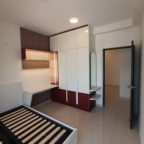 Bedroom under furnishing with a maroon-and-white gloss wardrobe, a built-in study nook with backlit open shelving, and an arched dressing mirror.