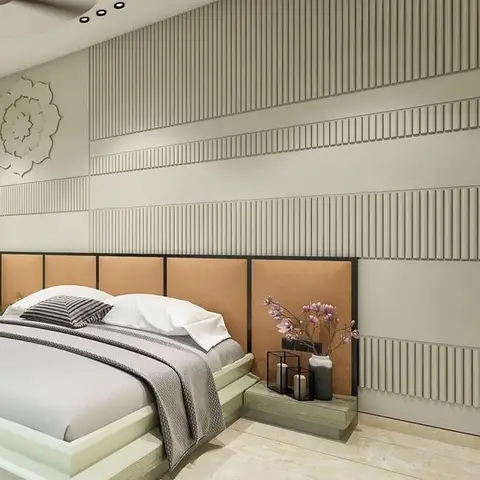 Bedroom wall in horizontal reeded ivory bands with a carved mandala roundel, tan upholstered headboard panels in slim dark frames and a stepped low platform