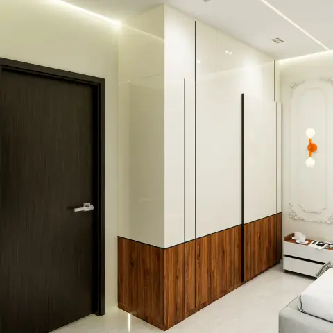 Bedroom wardrobe wall in white gloss over a walnut lower band with tall black recessed pulls, next to a dark wenge flush door