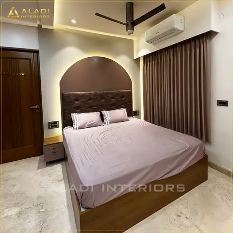 Bedroom where a brown button-tufted headboard sits inside a backlit mauve arch panel, with a teak platform bed base
