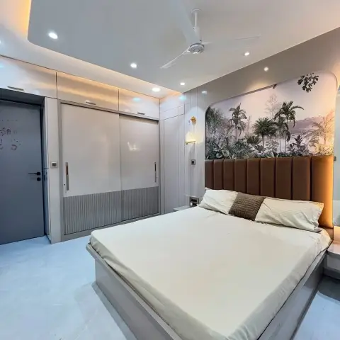 Bedroom where a curved-corner tropical palm mural sits above a tan channel-tufted headboard