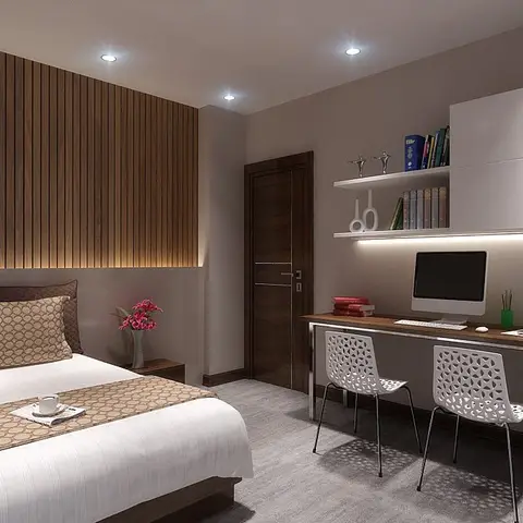Bedroom where a full-width walnut fluted headboard wall is grazed by a warm strip at its base