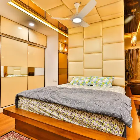 Bedroom where cream leatherette upholstered panels climb the headboard wall and continue across the ceiling