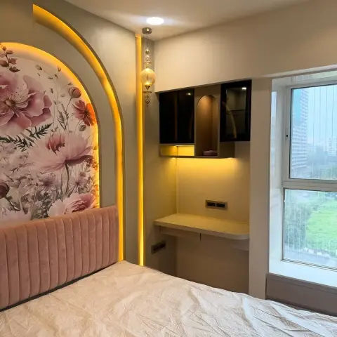 Bedroom with a backlit arched niche behind a pink channel-tufted headboard and floral wallpaper