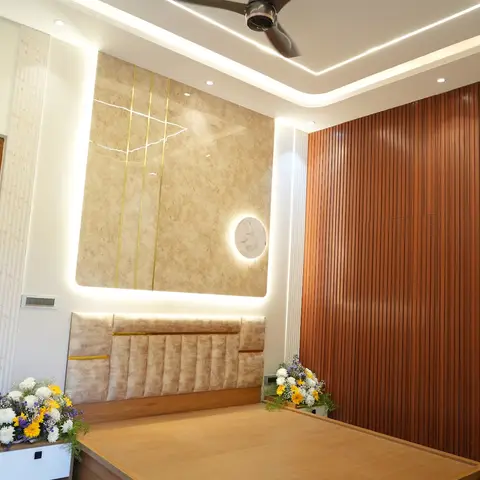 Bedroom with a backlit marble-and-brass inlay feature wall behind a channel-tufted headboard, and a fluted wood-panelled side wall