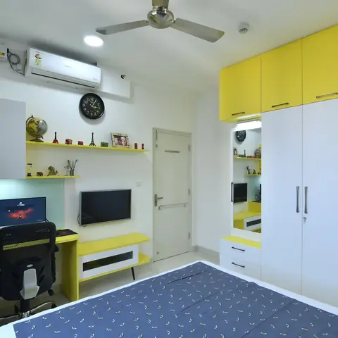 Bedroom with a bright yellow-and-white wardrobe wall and a matching yellow study desk with a wall-mounted TV unit.
