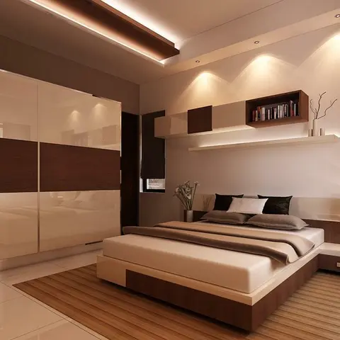 Bedroom with a cream and wood-grain sliding wardrobe, a low platform bed and a backlit floating shelf styled with books.