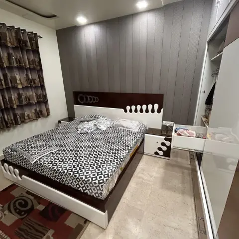 Bedroom with a custom wave-cut white and wenge headboard bed against a grey textured wall, a matching bedside table