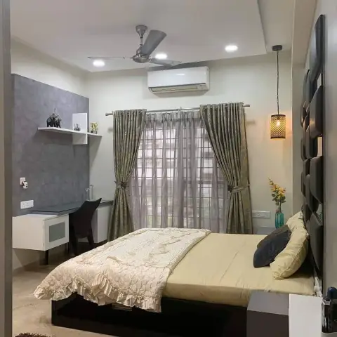 Bedroom with a dark leatherette headboard wall in stacked cushion modules, a perforated metal pendant hanging beside it