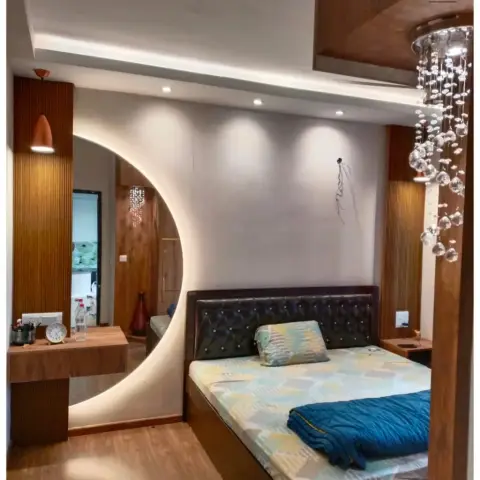 Bedroom with a dark tufted leatherette bed beside a large circular backlit mirror cut into fluted teak panelling