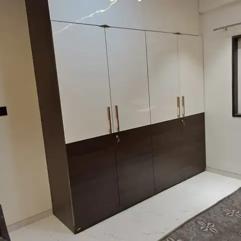 Bedroom with a floor-to-ceiling four-shutter wardrobe in cream gloss over a wenge laminate lower band