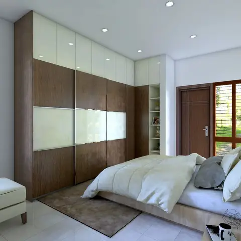 Bedroom with a floor-to-ceiling wood-and-frosted-glass sliding wardrobe wall, plush white bedding, and a cream upholstered bench at the foot of the bed.