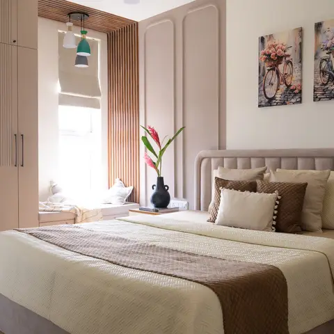 Bedroom with a fluted wardrobe, panel-moulded walls, a wood-slat window seat nook with pendant lights