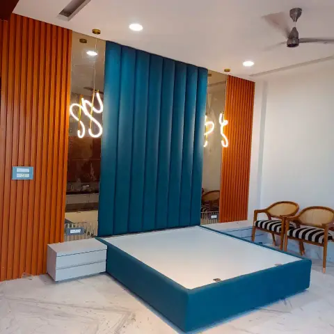 Bedroom with a full-height teal channel-tufted headboard wall set between rust fluted panels and bronze mirror strips carrying squiggle neon lights