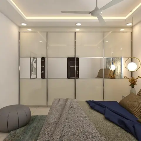 Bedroom with a full-wall mirrored sliding wardrobe reflecting the room and a botanical leaf print above a low pouf.