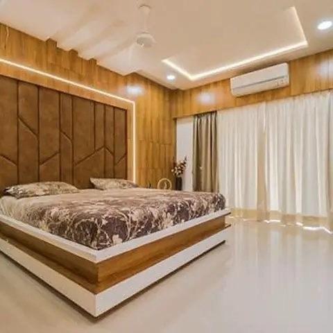 Bedroom with a geometric wood-and-leather panelled headboard wall, cove-lit false ceiling, and sheer-and-blackout curtain layering.