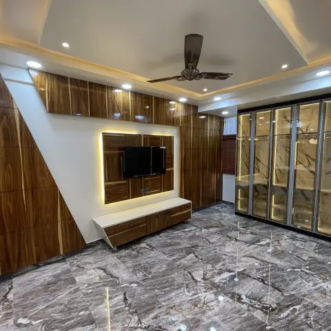 Bedroom with a geometric wood-veneer accent wall and backlit TV panel, a full-height wardrobe with backlit marble-look glass shutters, a coffered POP ceiling