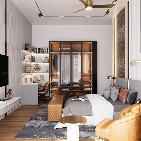 Bedroom with a glass-and-bronze open wardrobe, a built-in study desk with lit display shelving, a mustard leather tufted armchair, and a grey upholstered bed.
