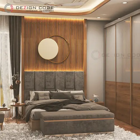 Bedroom with a grey channel-tufted headboard beneath a backlit fluted-wood panel wall and a circular mirror-and-disc art piece