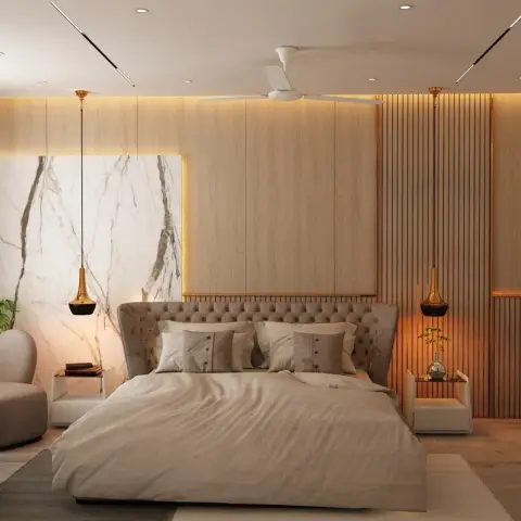 Bedroom with a marble-slab headboard backdrop, light oak fluted panelling, brass drop pendants, and a fireside-style armchair seating nook by the window.