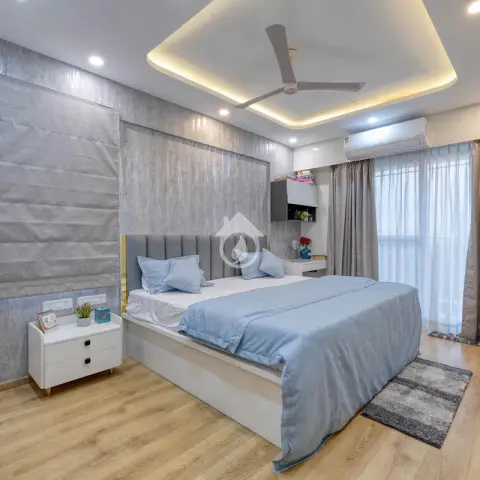 Bedroom with a mottled silver-grey textured back wall and matching grey roman blind