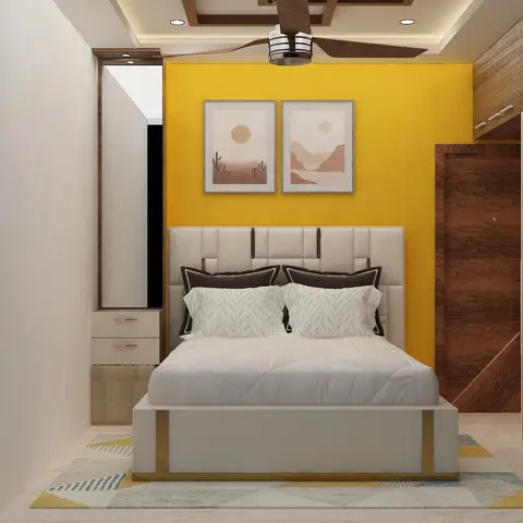 Bedroom with a mustard-yellow accent wall behind an upholstered bed and a wood-grain sliding wardrobe on the side wall.