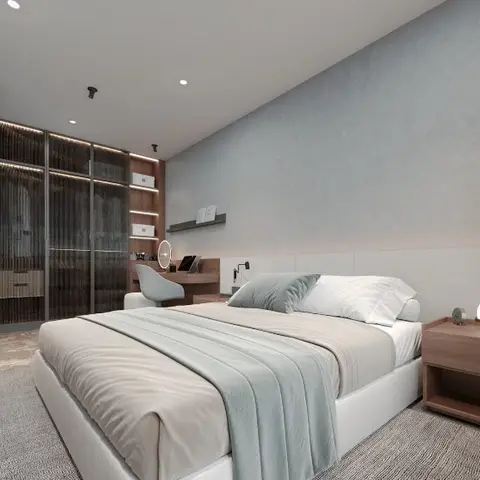 Bedroom with a reeded-glass wardrobe wall lit by LED profile lighting and an attached dressing nook with a mirror and chair.