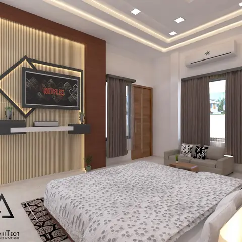 Bedroom with a ribbed wood-panel TV feature wall, cove-lit ceiling, and a separate seating nook with a sofa and study desk beside tall curtained windows.