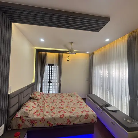 Bedroom with a slatted wood ceiling frame wrapping the bed wall, and a long upholstered storage bench along the window with LED under-lighting.