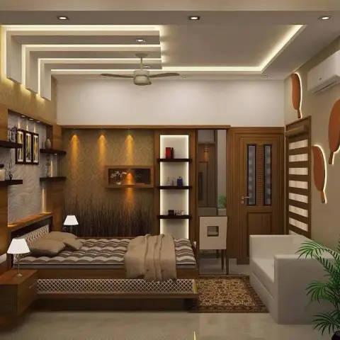 Bedroom with a stepped cove-lit POP ceiling, a damask-wallpaper headboard wall lit by three spots, and a low platform bed with a white lattice front.