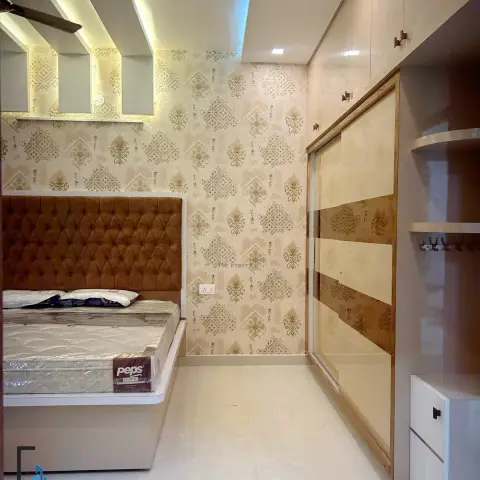 Bedroom with a tufted mustard-brown velvet headboard against a gold damask wallpaper wall