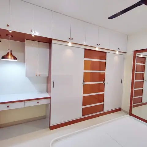 Bedroom with a white and maroon glossy sliding-door wardrobe, a matching full-length mirror unit