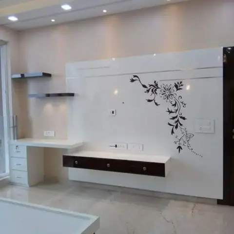 Bedroom with a white gloss TV wall accented by a black floral wall decal, a floating black-trimmed console below