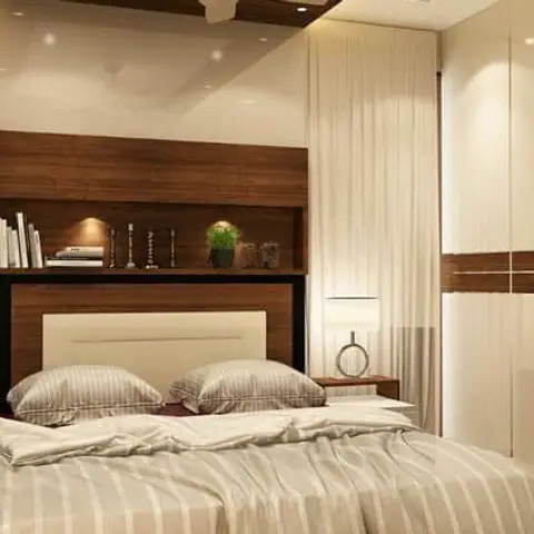 Bedroom with a wood headboard wall featuring a built-in display niche, a glossy white wardrobe with a wood accent band, and matching bedside lamps.