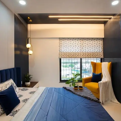 Bedroom with charcoal fluted panelling wrapping from wall onto the ceiling band, a navy velvet channel headboard