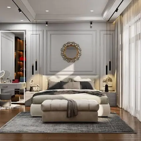 Bedroom with classic panel-moulded walls, a round gold mirror above the bed, twin pendant lights, and a walk-in closet visible through the open mirrored door.