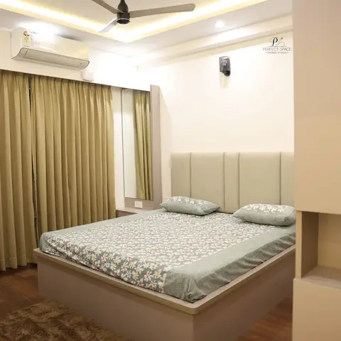 Beige bedroom with a low cream-laminate storage bed under a channel-tufted headboard, grey floral bedding