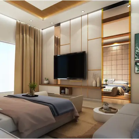 Beige fabric-textured panelled TV wall with slim brass reveals and a full-height mirror strip that reflects the bed, faced by a grey sofa on a jute rug.