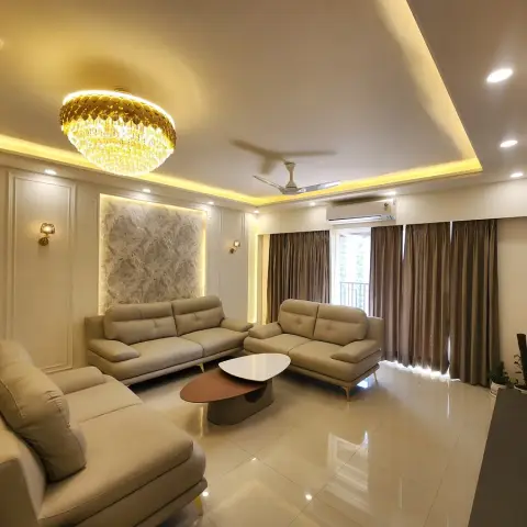Beige leather three-seater and two-seater around a two-tier oval coffee table, facing a backlit rough stone panel set into white moulded wall framing
