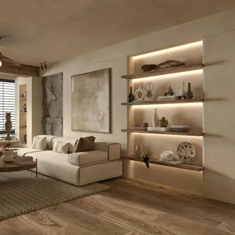 Beige lime-plaster living room where four live-edge walnut shelves sit in an LED-backlit niche styled with pale ceramics