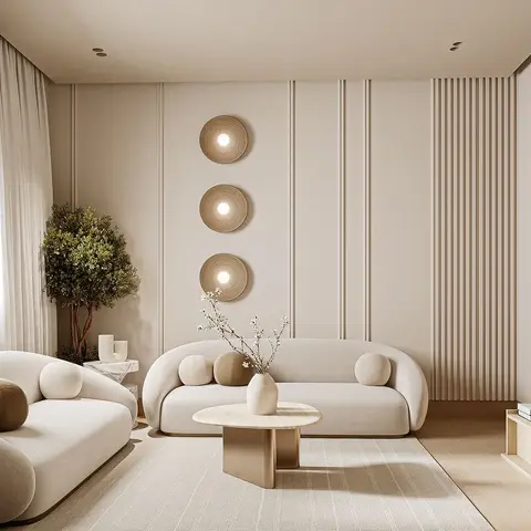 Beige living room render with two curved bouclé sofas around a brass-base marble coffee table, a fluted panel accent strip