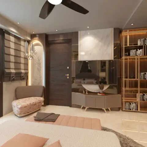 Blush-and-brass bedroom seen from the foot of the bed, with a floral-upholstered chaise under a backlit carved feather niche