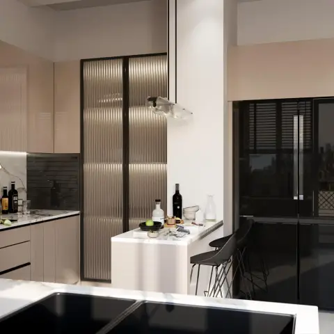 Blush-beige gloss kitchen where a black-framed fluted glass tall unit sits between the run and a slim breakfast bar with two black wire stools