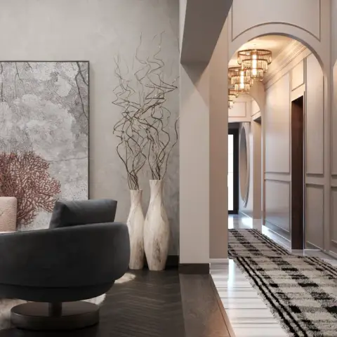 Blush sofa and charcoal swivel chair in front of an oversized coral-print canvas, opening onto an arched moulded passage lined with a grid of framed prints